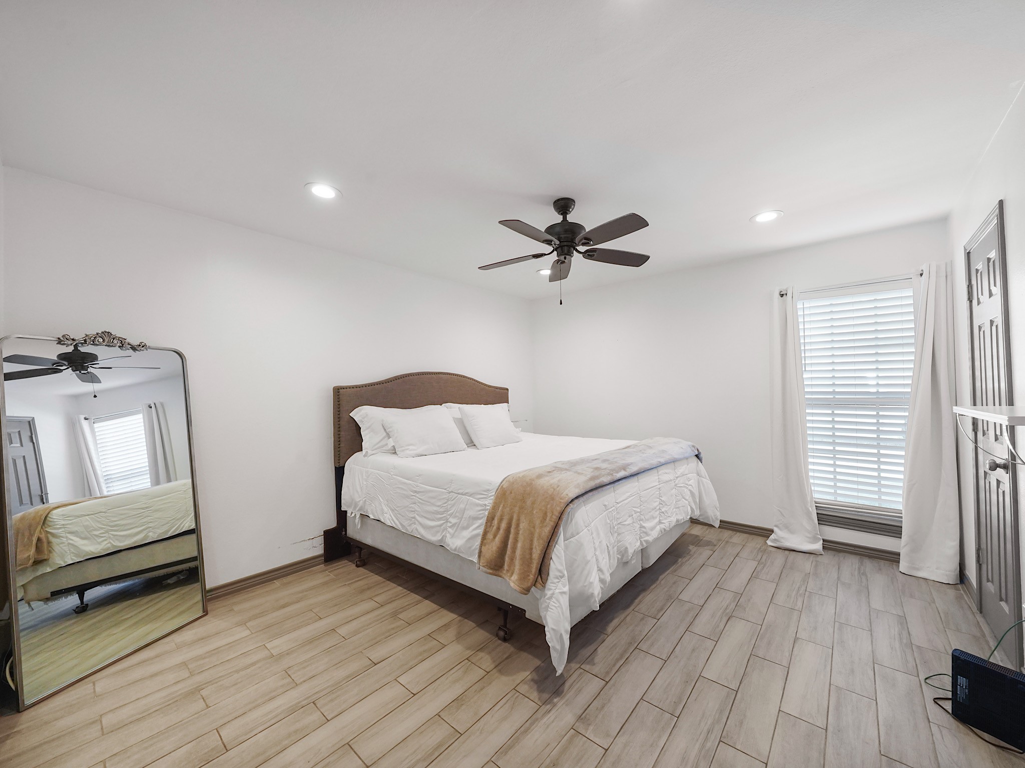 9616 Long Point Road, Unit 47 Houston, TX 77055 - Photo 12 of 15 The primary bedroom is bathed in natural light, accented by soft tones that create a comfortable atmosphere, and is complete with an en suite bathroom.