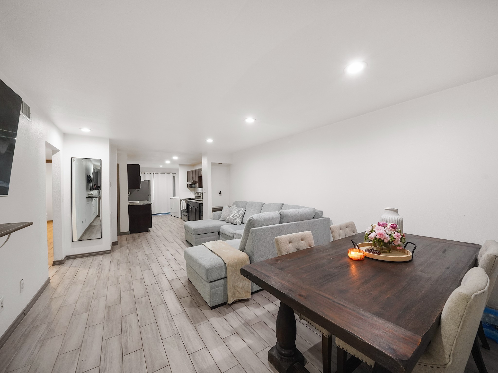 9616 Long Point Road, Unit 47 Houston, TX 77055 - Photo 3 of 15 The spacious living room featuring wood-like tile floors flows effortlessly into the kitchen, with a welcoming dining area sitting just to the right upon entry.