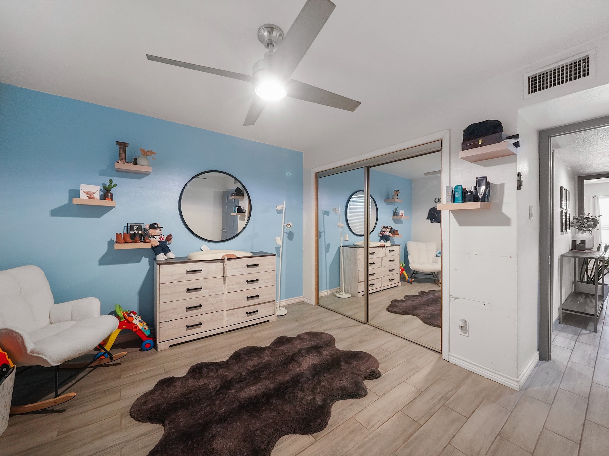 9616 Long Point Road, Unit 47 Houston, TX 77055 - Photo 9 of 15 Wood-look tile flooring create a restful bedroom, with a ceiling fan adding comfort to the space.