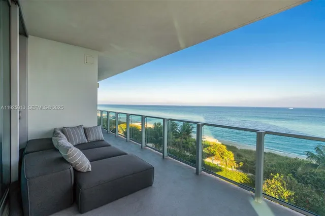 a living room with furniture a large window and a table