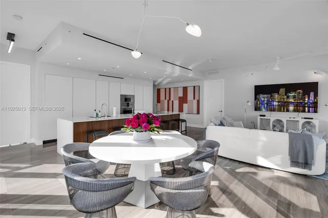 a living room with dining room and kitchen view