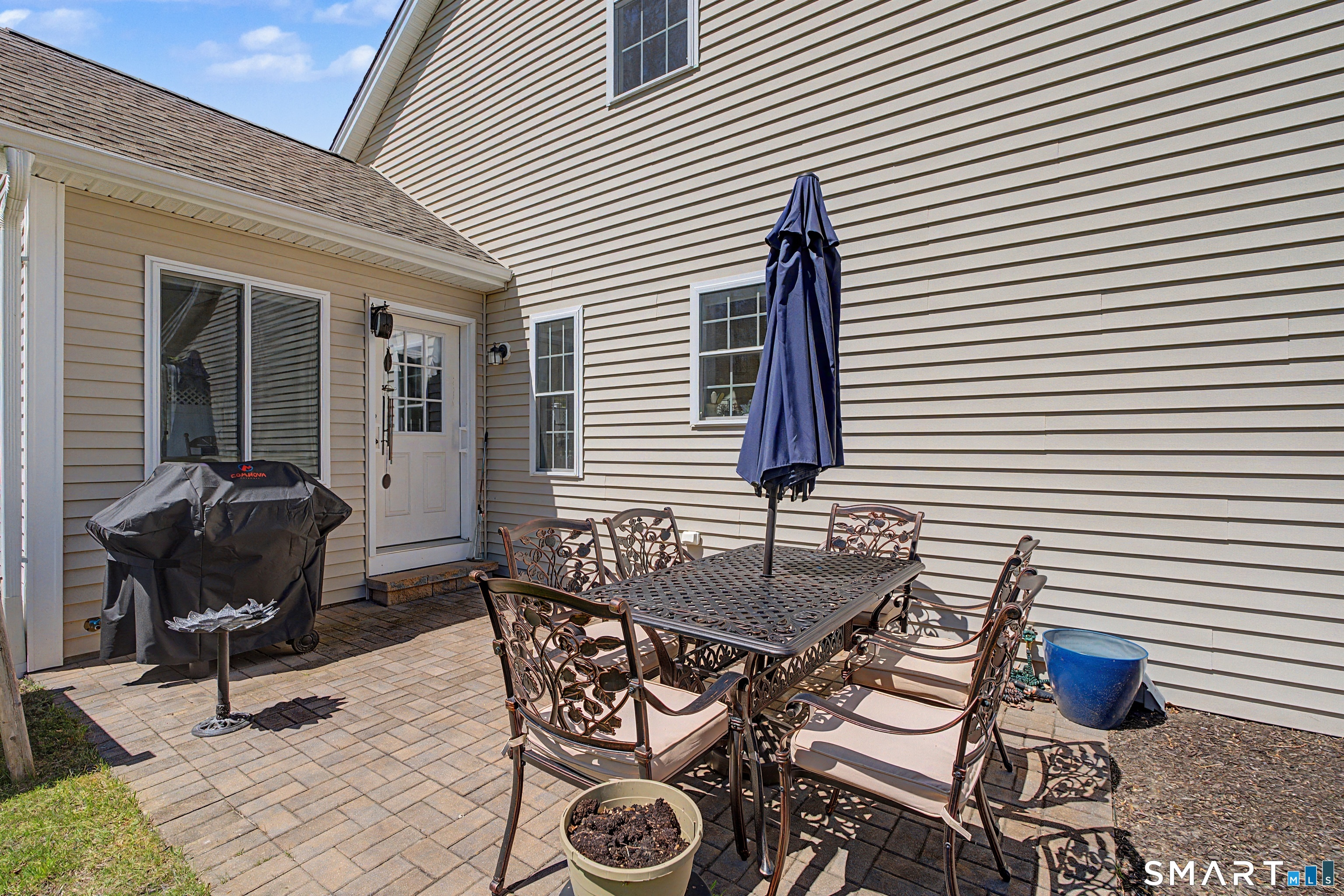 211 Meadowbrook Road, Unit 211 Oxford, CT 06478 - Photo 35 of 38 Private patio just off the main living area-ideal for outdoor dining, grilling, and relaxing in a low-maintenance setting.