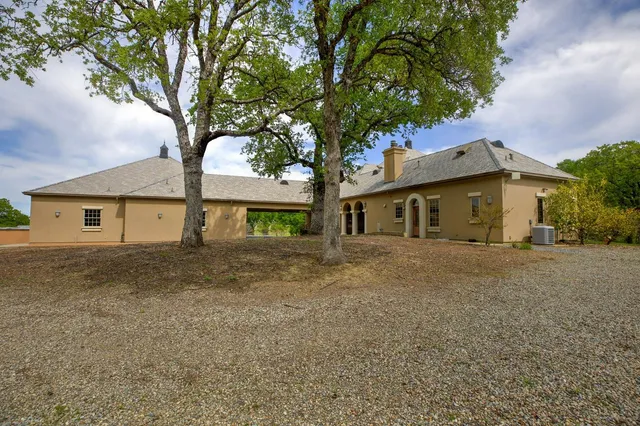 a living room with furniture a flat screen tv and a large window