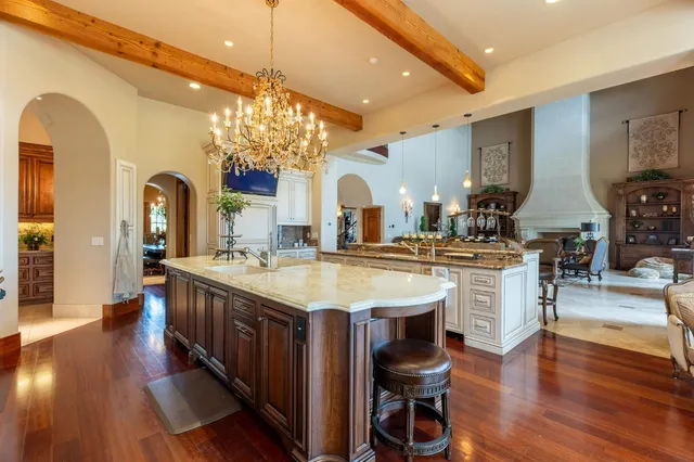 a spacious bedroom with bed and a chandelier