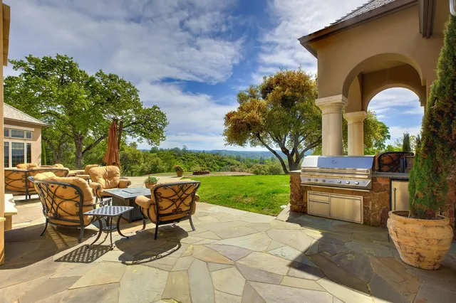 a dining hall with stainless steel appliances granite countertop dining table and chairs