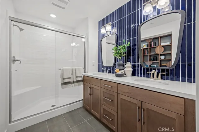 a spacious bathroom with a shower sink and mirror