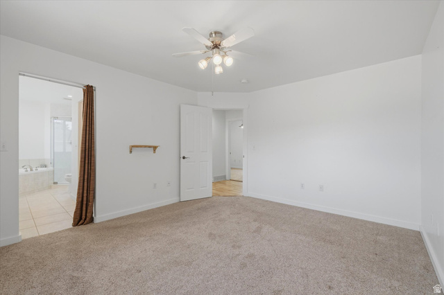 791 East Saddle Road Grantsville, UT 84029 - Photo 20 of 46 Spacious room featuring carpet flooring, a ceiling fan with integrated lighting, and a white paneled door