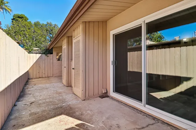 a view of a house with backyard and wooden fence
