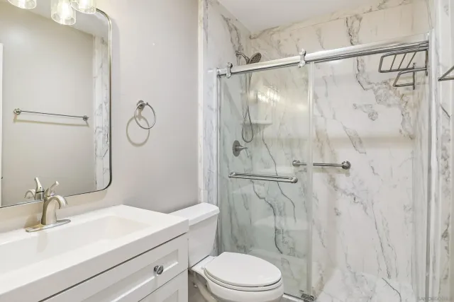 a bathroom with a sink toilet and shower