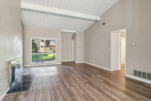 wooden floor in an empty room with a window