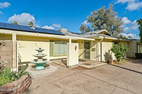 a view of a patio with table and chairs and potted plants