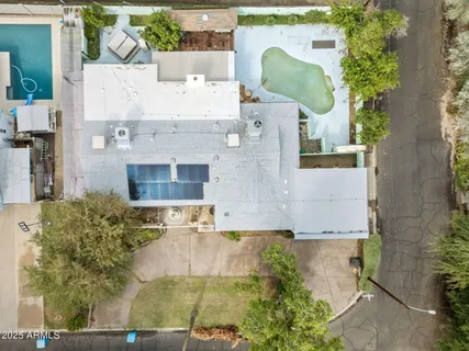 an aerial view of a house with a yard