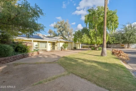 a view of a house with garden and patio