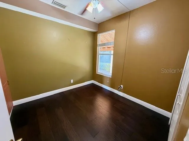 a view of room with window and wooden floor