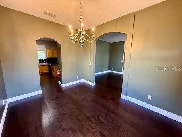 a view of a livingroom with wooden floor and furniture