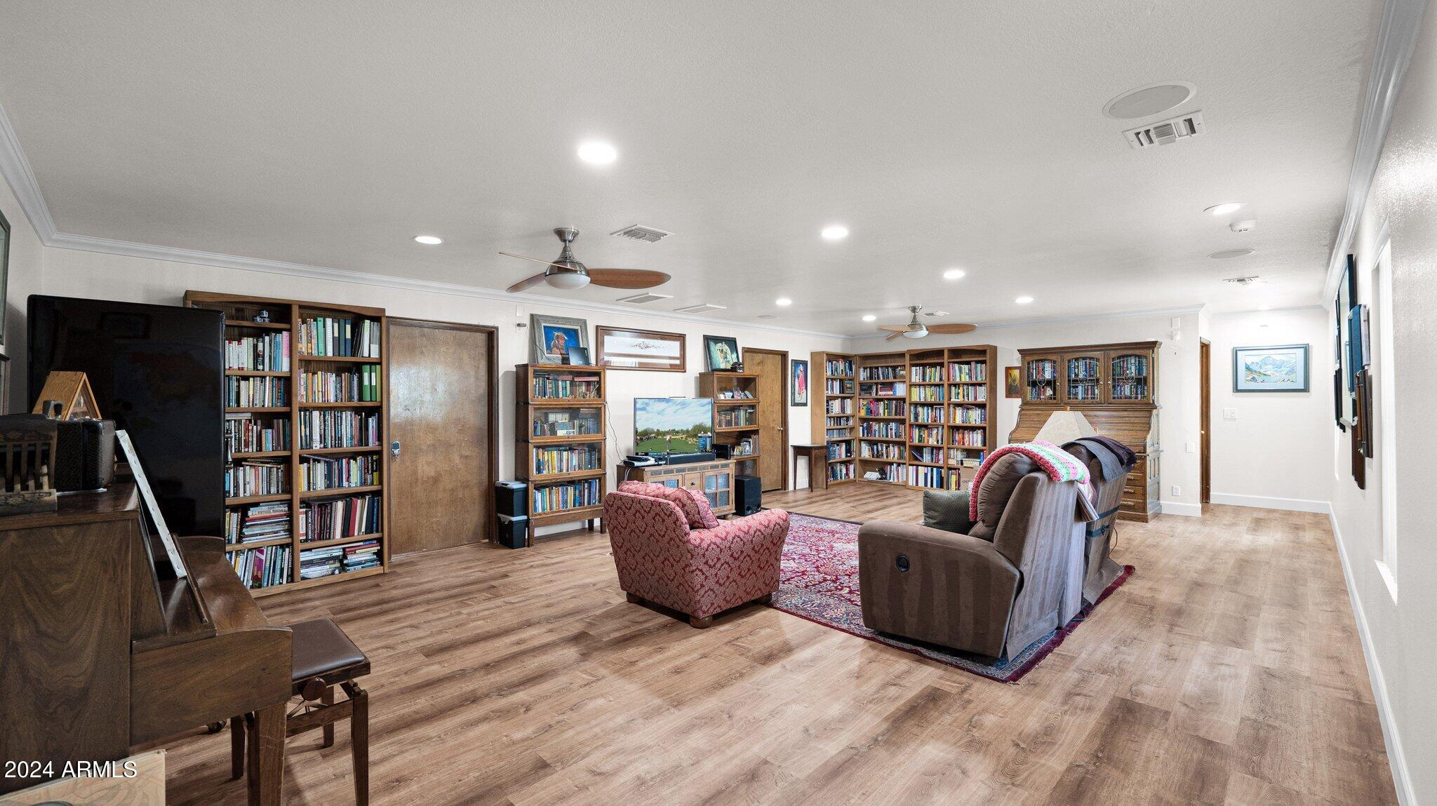 814 East Harwell Road Gilbert, AZ 85234 - Photo 14 of 35 a living room with furniture and a book shelf
