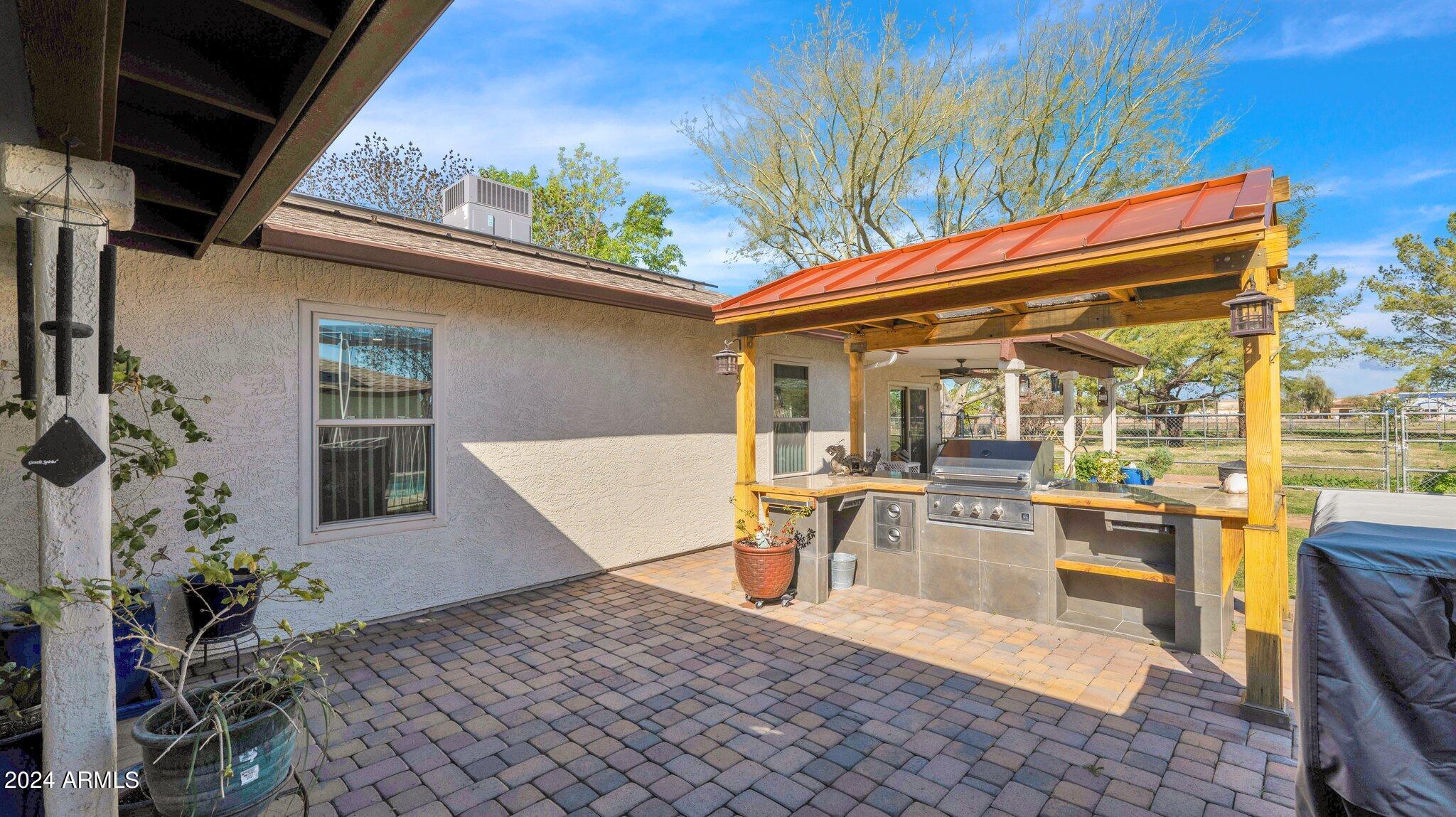 814 East Harwell Road Gilbert, AZ 85234 - Photo 28 of 35 a view of a patio with table and chairs potted plants and floor to ceiling window