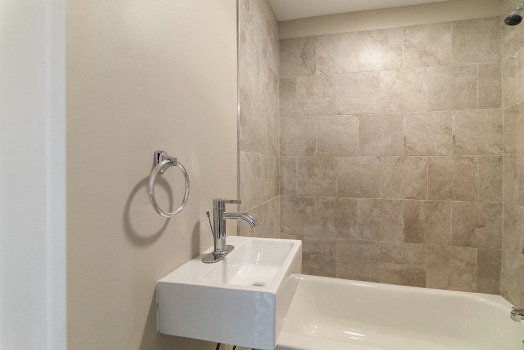 43 Wait Street Springfield, MA 01104 - Photo 8 of 18 a bathroom with a sink a toilet and shower