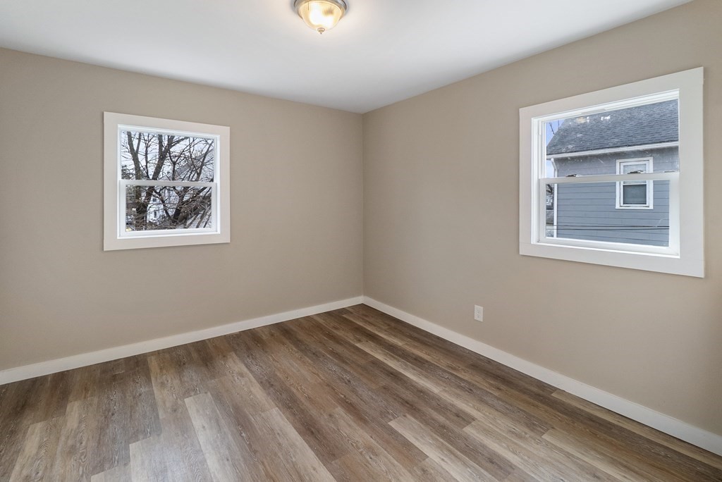 43 Wait Street Springfield, MA 01104 - Photo 10 of 18 a view of an empty room with wooden floor and a window