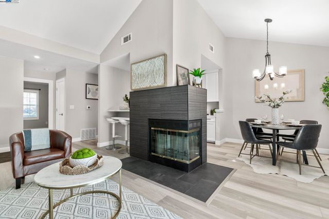 a living room with furniture a table and a fireplace
