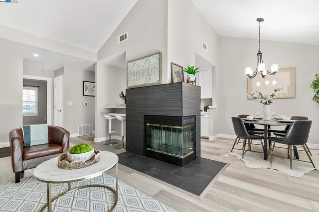 a living room with furniture a table and a fireplace