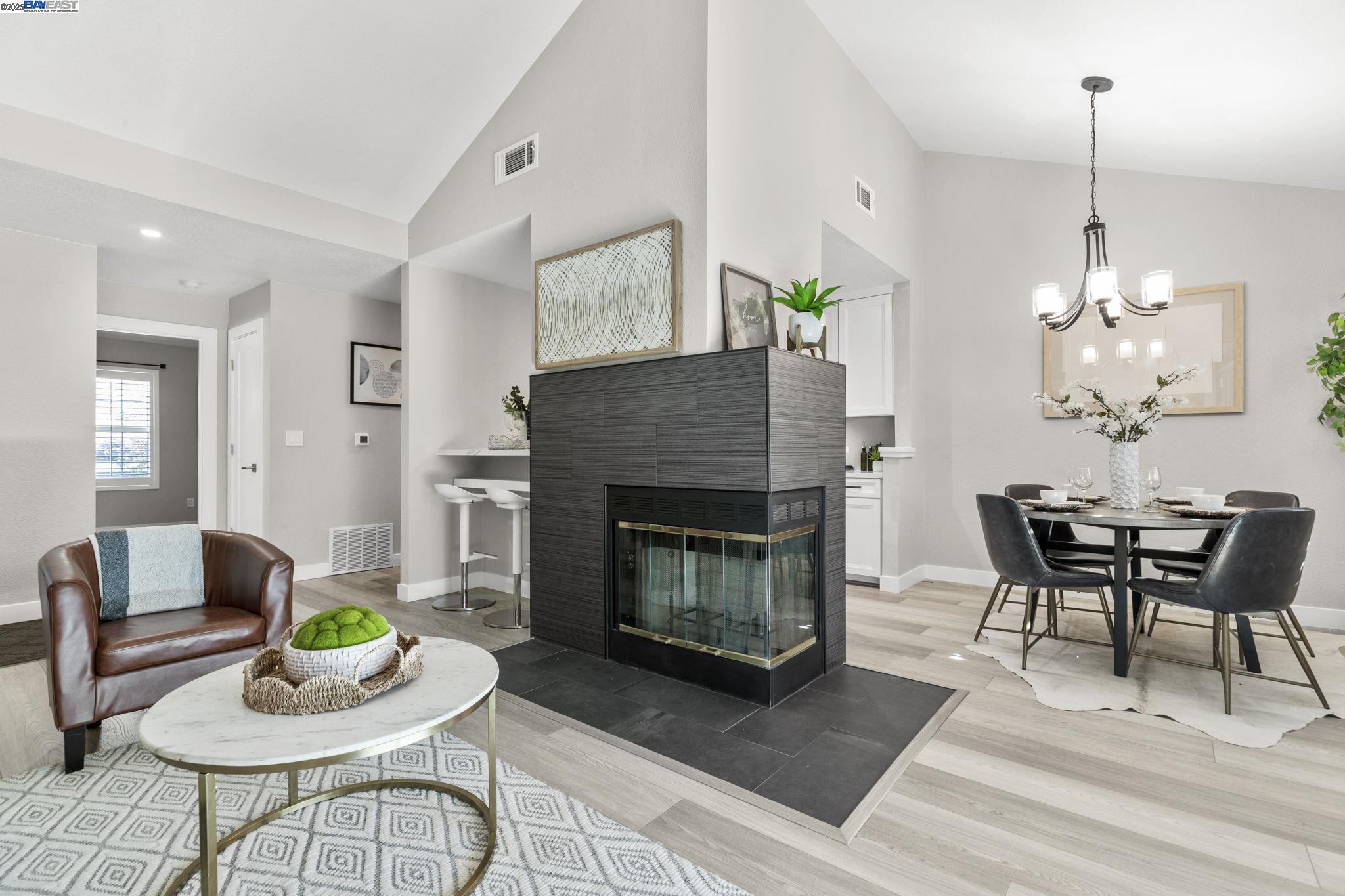 a living room with furniture a table and a fireplace