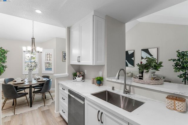 a kitchen with a sink cabinets and wooden floor