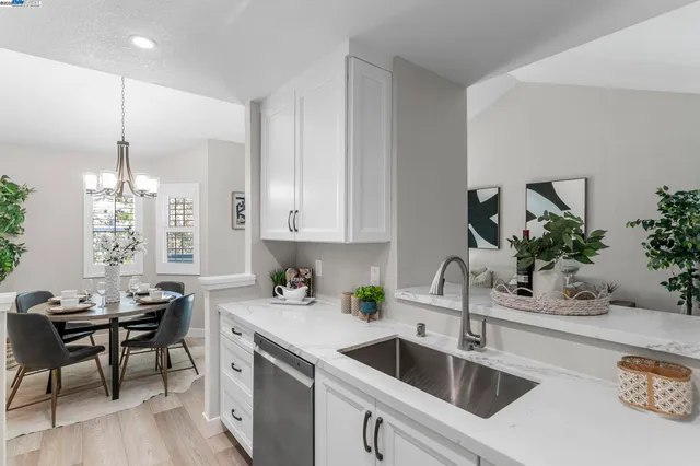 a kitchen with a sink cabinets and wooden floor