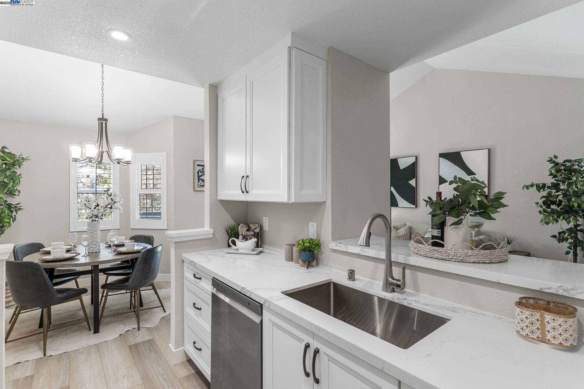 8170 Mountain View Drive, Unit F Pleasanton, CA 94588 - Photo 18 of 51 a kitchen with a sink cabinets and wooden floor