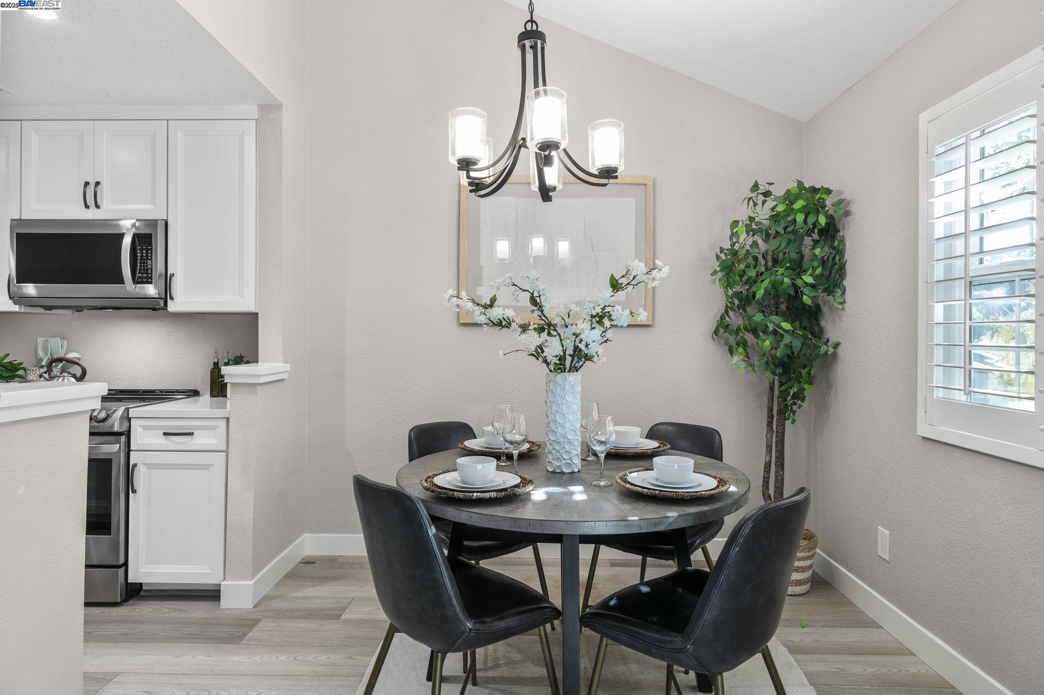 8170 Mountain View Drive, Unit F Pleasanton, CA 94588 - Photo 19 of 51 a dining room with furniture potted plants and wooden floor