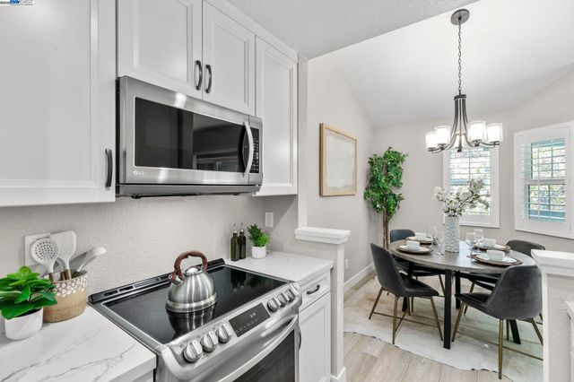a kitchen with a sink a microwave and cabinets