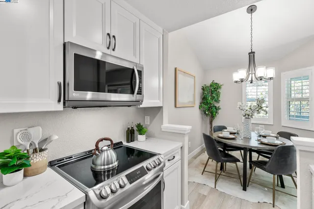 a kitchen with a sink a microwave and cabinets