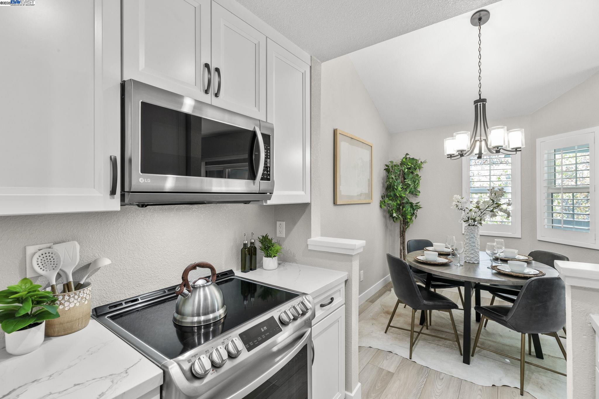 8170 Mountain View Drive, Unit F Pleasanton, CA 94588 - Photo 22 of 51 a kitchen with a sink a microwave and cabinets