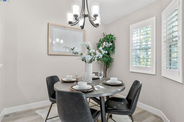 a view of a dining room with furniture wooden floor and chandelier