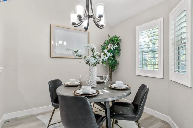a view of a dining room with furniture wooden floor and chandelier