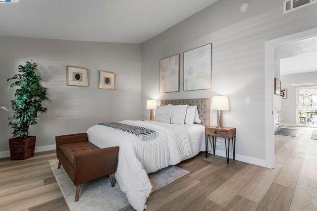 a bedroom with bed and a potted plant