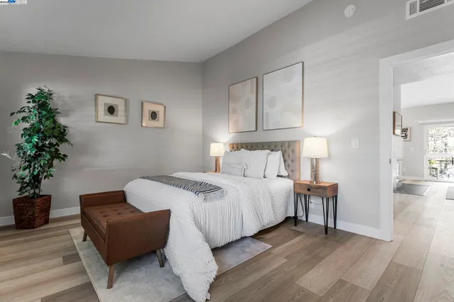 a bedroom with bed and a potted plant