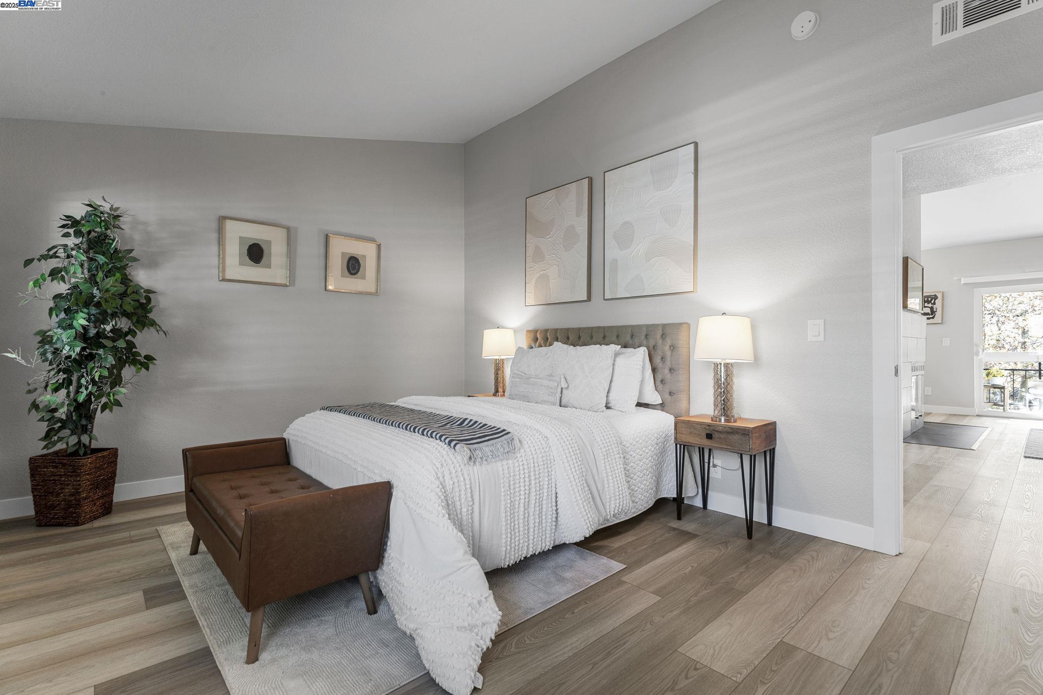 8170 Mountain View Drive, Unit F Pleasanton, CA 94588 - Photo 26 of 51 a bedroom with bed and a potted plant