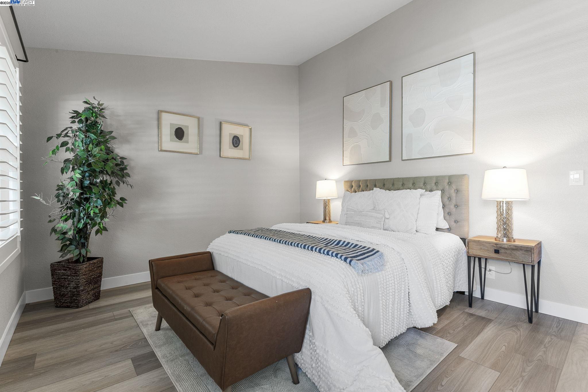 8170 Mountain View Drive, Unit F Pleasanton, CA 94588 - Photo 28 of 51 a bedroom with a bed and a potted plant
