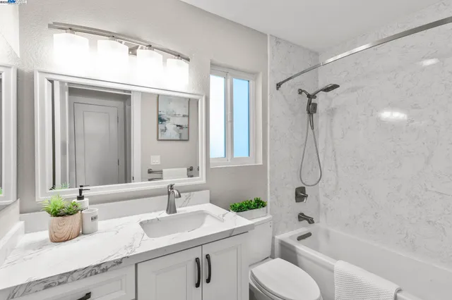 a bathroom with a sink a toilet and a bathtub