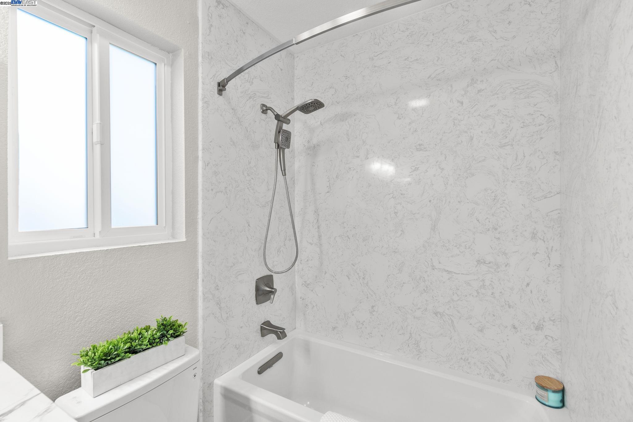 8170 Mountain View Drive, Unit F Pleasanton, CA 94588 - Photo 30 of 51 a bathroom with a bath tub with a shower