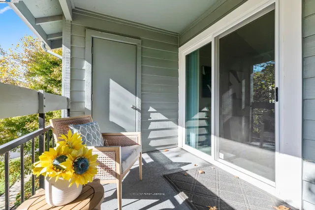 a balcony with table and chairs