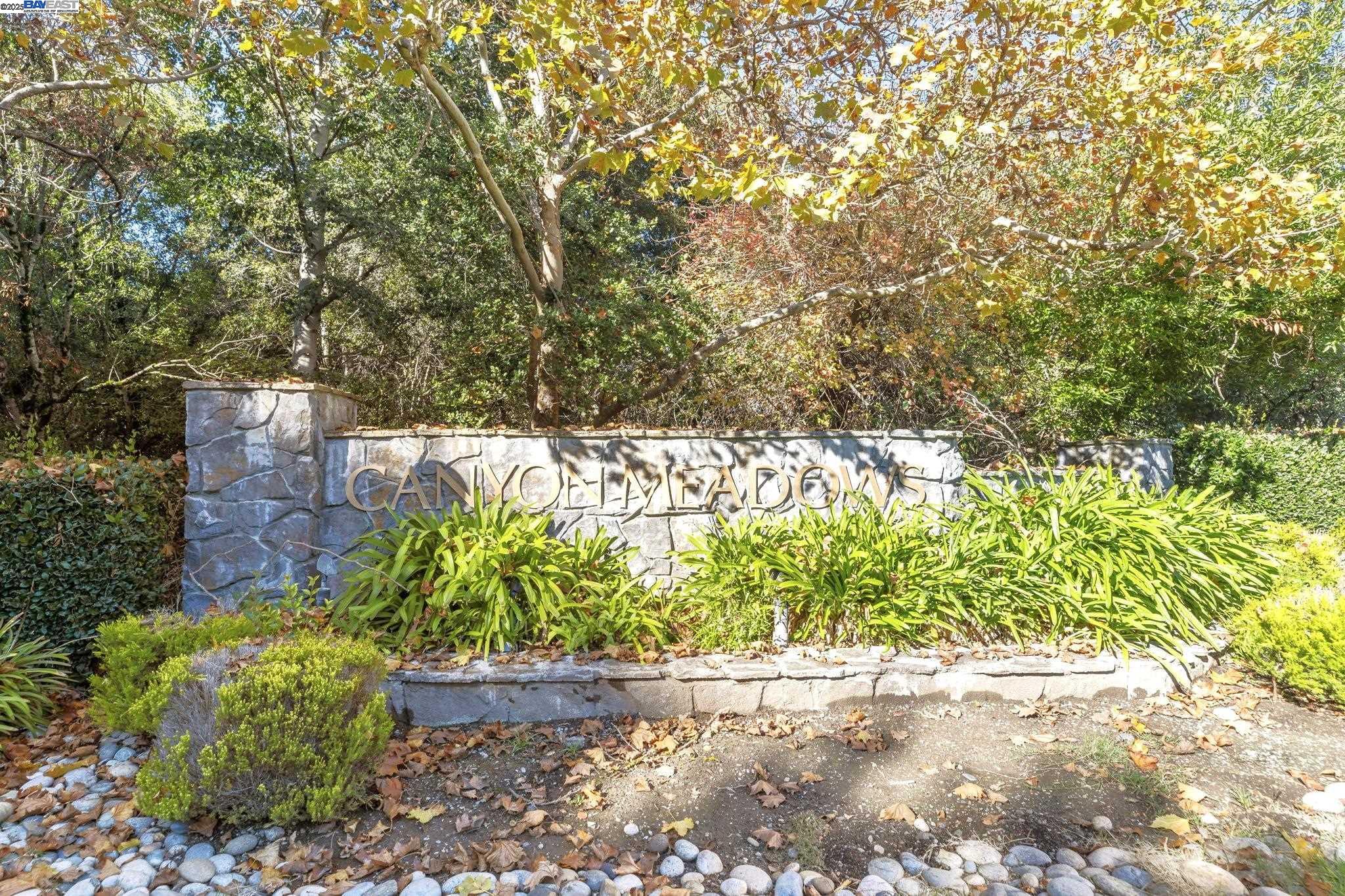 8170 Mountain View Drive, Unit F Pleasanton, CA 94588 - Photo 41 of 51 a wooden bench with a tree in the background