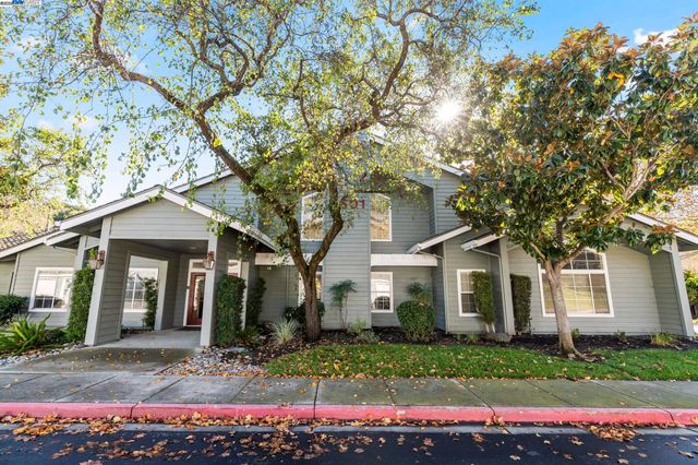 a view of a swimming pool with a yard and palm trees
