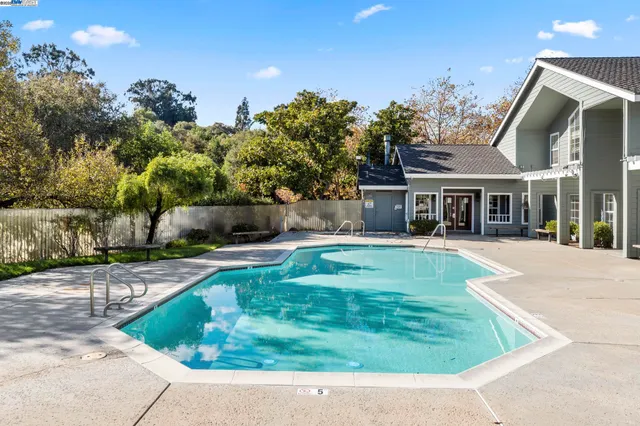 front view of a house with a yard and an outdoor seating