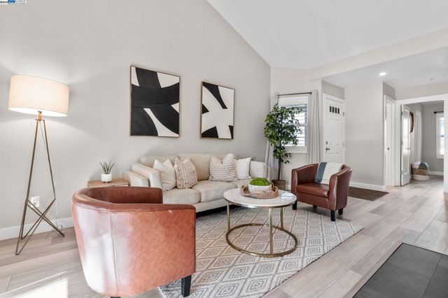 a living room with furniture and a lamp