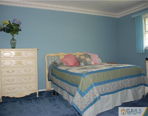 5 Chandler Road Edison, NJ 08820 - Photo 12 of 23 a bedroom with a bed and a dresser