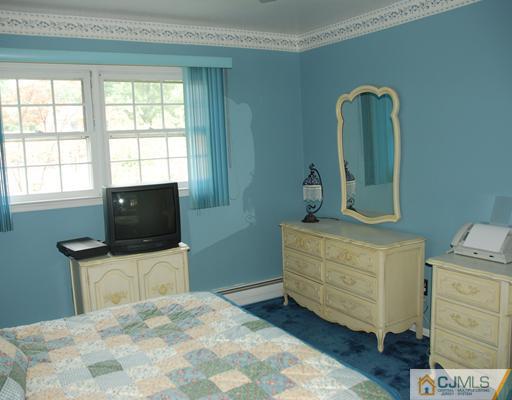 5 Chandler Road Edison, NJ 08820 - Photo 13 of 23 a bedroom with a bed and a television