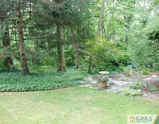 5 Chandler Road Edison, NJ 08820 - Photo 20 of 23 a backyard of a house with a table and chairs