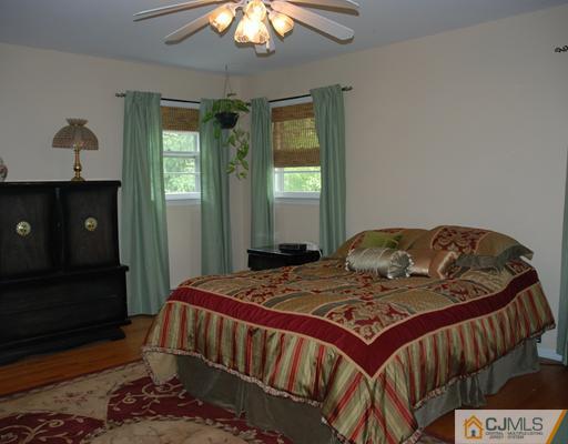 5 Chandler Road Edison, NJ 08820 - Photo 9 of 23 a bedroom with a bed and a chandelier